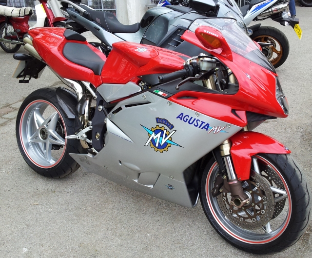an mv augusta in red and silver ona  busy car park